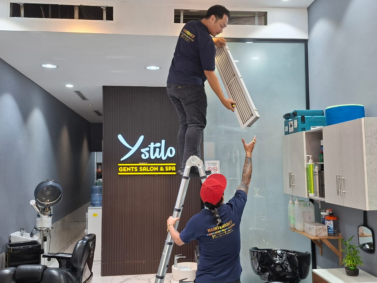Removing a ceiling AC return-air grille for filter access at a salon fit-out