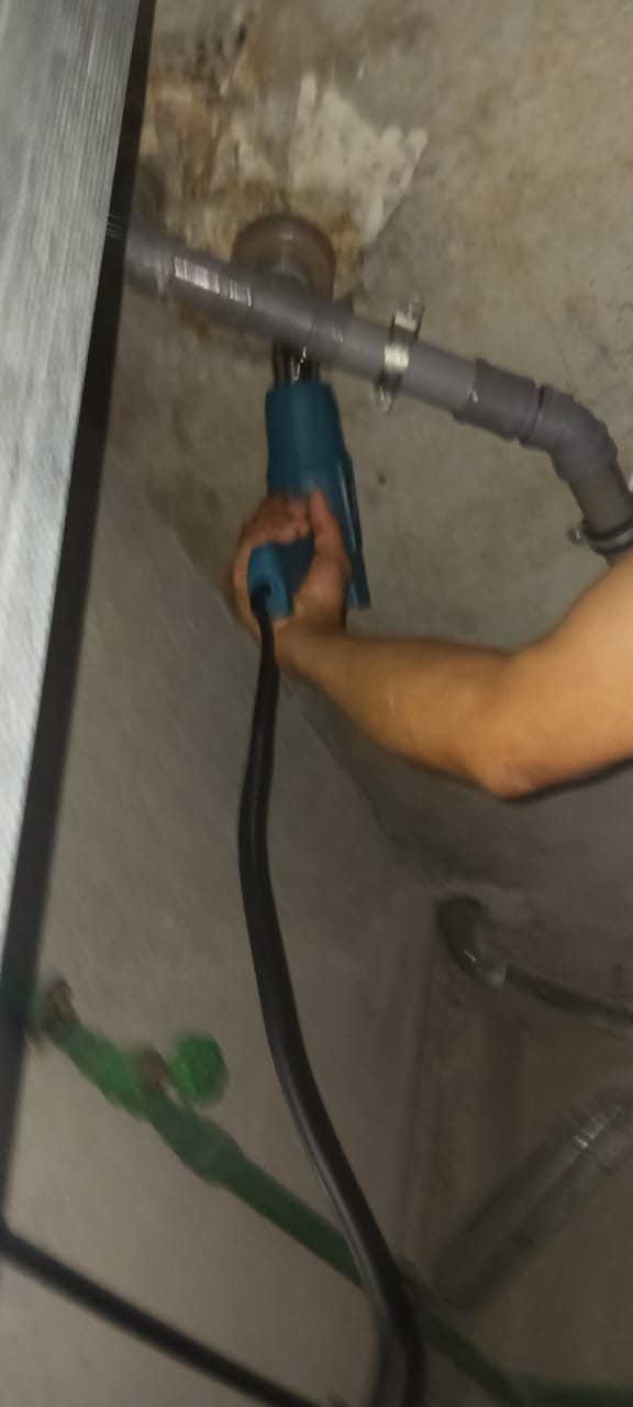Motorised drain snake clearing a stubborn waste line