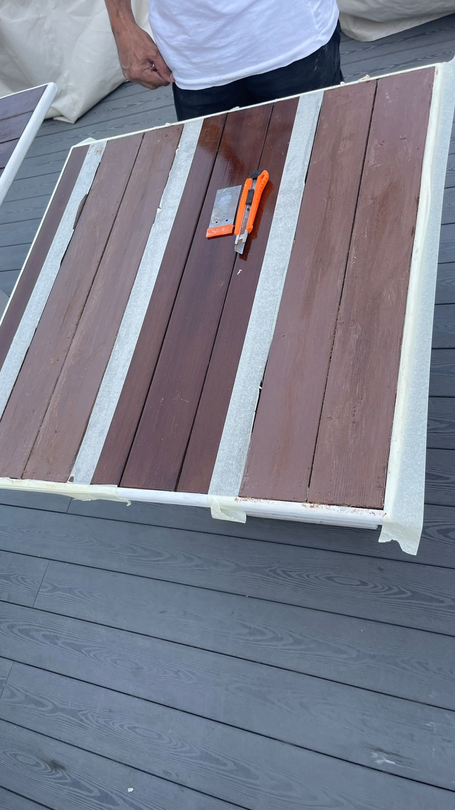 Timber-look tabletop being sanded and refinished for outdoor use