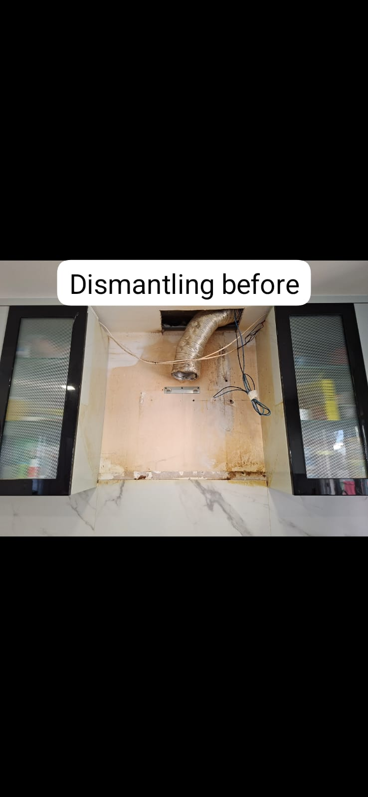 Dismantling the old hood — greasy backing exposed for cleanup