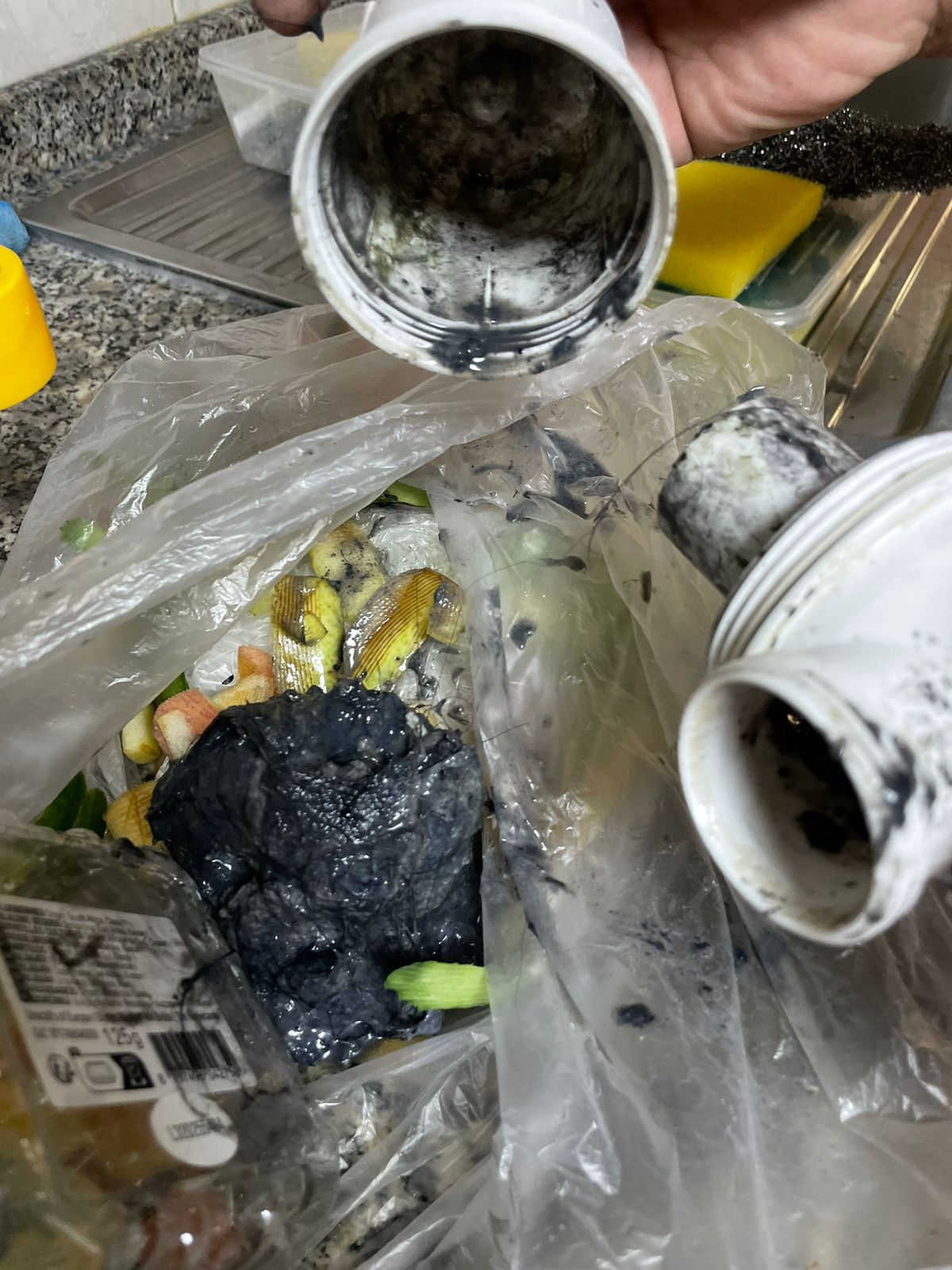 Heavy black sludge cleared from choked drain pipework