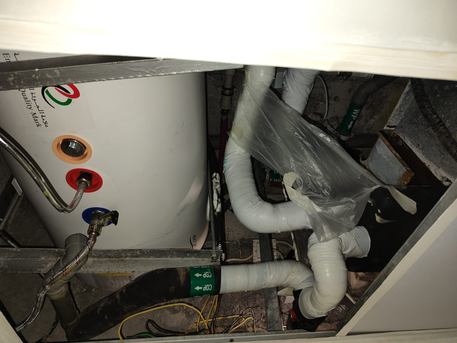 Old water heater and insulated pipework before reconnection