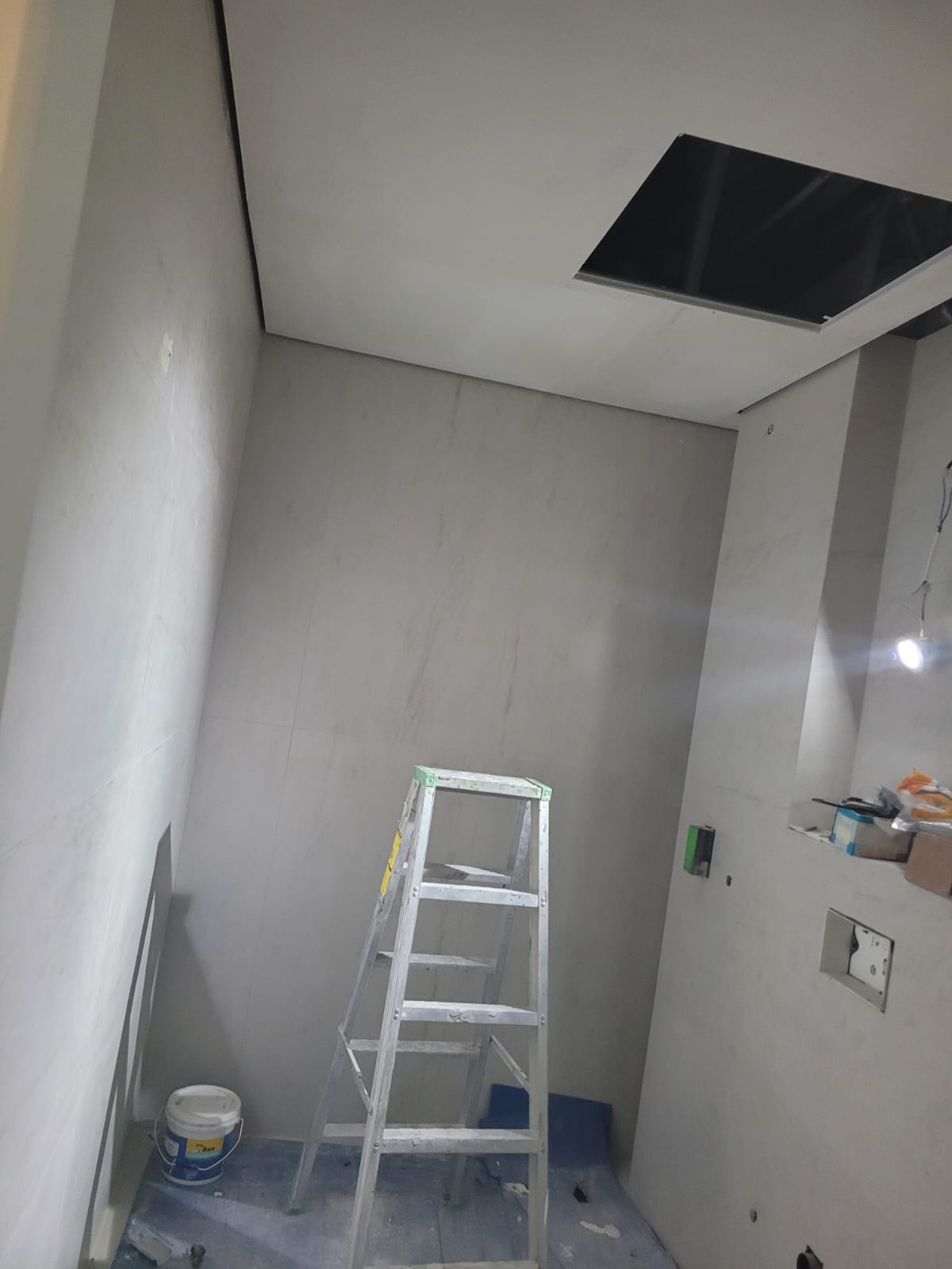 Wall tiling with ceiling access panel